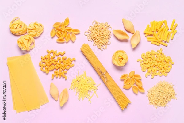Fototapeta Composition with different types of raw tasty pasta on pink background
