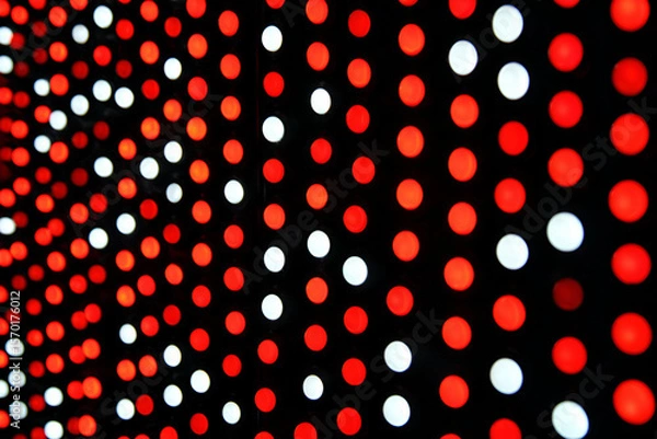 Fototapeta Vibrant Dot Array: A close-up shot reveals a mesmerizing display of red and white dots arranged in a dynamic pattern, creating an optical illusion of depth and movement.