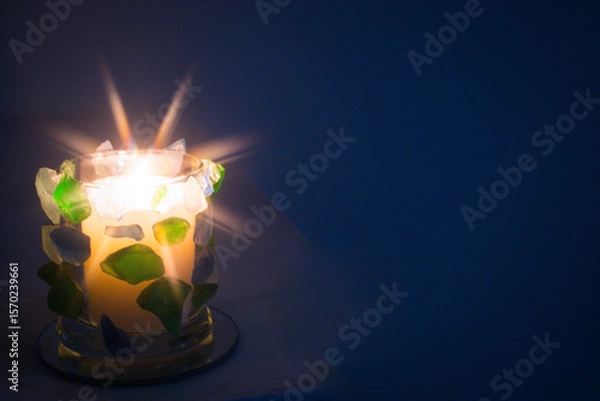 Fototapeta Hand crafted Green and Blue seaglass candle holder.  Star filter used for flame.