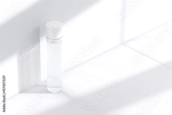Fototapeta Empty cylindrical bottle on a white surface.