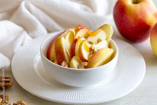 Fototapeta Healthy vegetarian Salad with apples, walnuts and honey in bowl