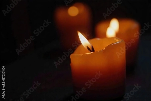 Fototapeta Flickering Candle Flame Macro Close-up of Warm Light in Darkness, Perfect for Meditation, Relaxation, and Spiritual Themes
