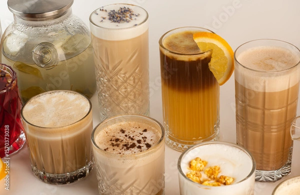 Fototapeta A collection of cozy autumn beverages with spices, popcorn, and fruit, showcasing coffee and tea varieties