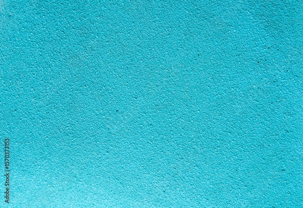 Fototapeta Bright turquoise textured surface, perfect for use as a background in design projects, presentations, templates, posters, or digital graphics with copy space.