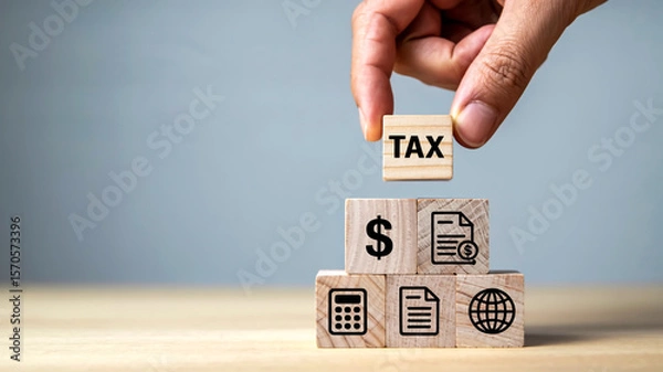 Fototapeta Close-up of hand placing wooden cube atop five-block pyramid on light wood surface, soft lighting