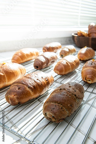 Fototapeta Freshly Baked Croissants and Rolls on a Cooling Rack