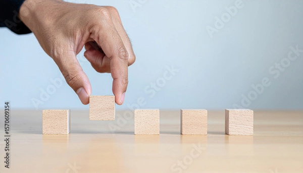 Fototapeta Concept of hand align. A horizontal line of  blank small wooden blocks. Strategic business component concept.