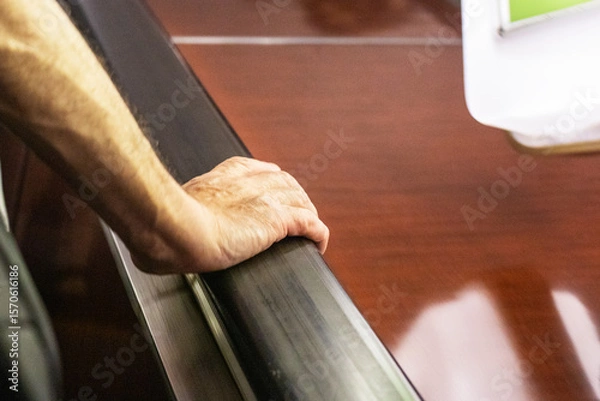 Obraz man's hand holding the railing on the escalator