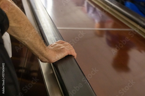 Obraz elderly man hand holding railing on escalator in subway