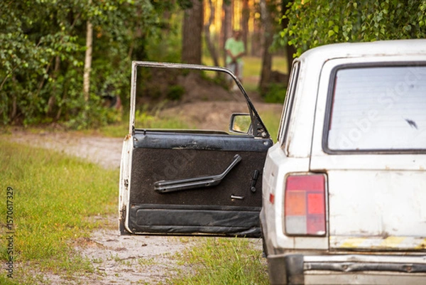 Obraz open door of an old car in the forest. weekend day