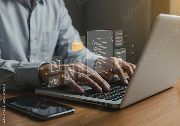Fototapeta Man Working on Laptop with Digital Document Management System Interface and Mobile Phone on Desk