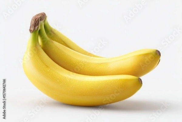 Fototapeta A bunch of ripe yellow bananas stacked on top of each other against a plain white background studio shot
