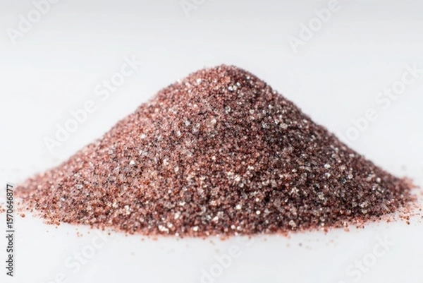 Fototapeta A mound of shiny rose gold glitter powder against a plain white background in a studio shot