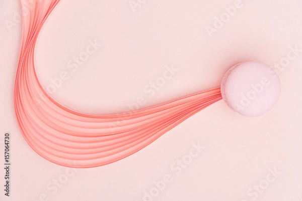 Fototapeta Pink Macaron and paper strips on a light background