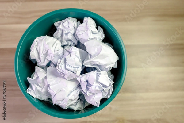 Fototapeta crumpled paper ball in trash can, paper waste, trash bin in office with crumple paper ball, work hard ideas concept