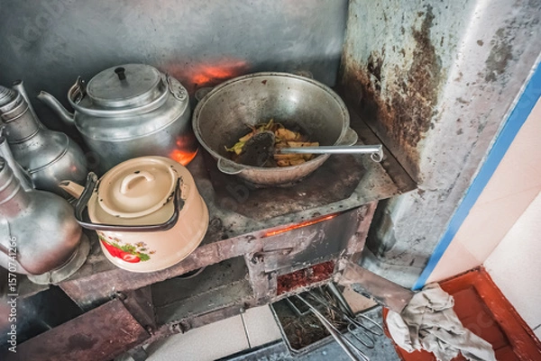 Fototapeta Cooking food on a traditional stove in the house of the Pamir population of the Pamirs in the village of Karakul