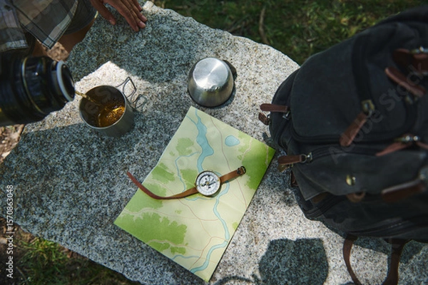 Fototapeta Exploration Essentials on Granite Surface Featuring Map, Compass, and Hiking Gear