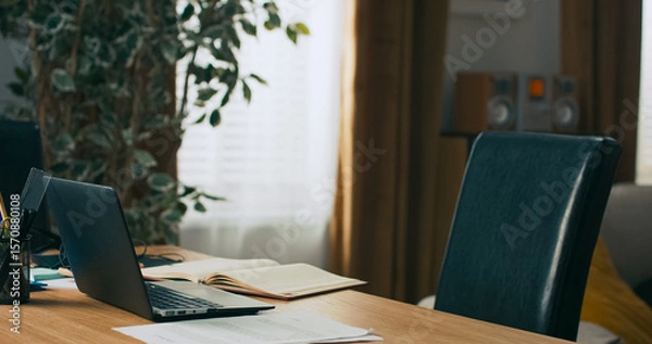 Fototapeta Working from home, fills out documents, completes schedule, enters data into system
