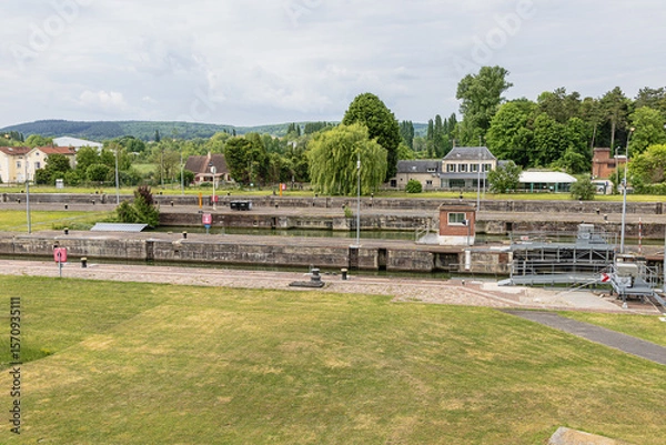 Fototapeta Side view of the locks of Amfreville-sous-les-Monts seen from the overpass over the Seine near Rouen