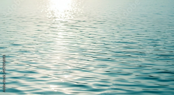Fototapeta Rippled water surface with sunlight reflections in soft aqua and white tones