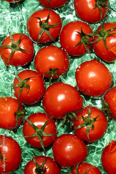 Fototapeta Clean Ripe Tomatoes Dropped into Water Top View