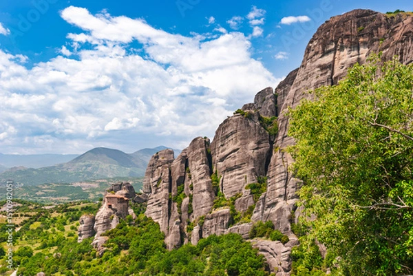 Fototapeta Ancient Meteora monastery perched on cliff edge beside massive rock formation in Greece