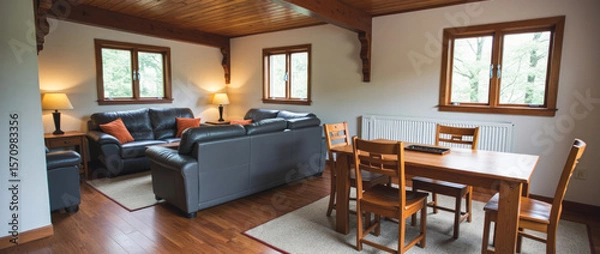 Fototapeta Simple and Sturdy Open-Plan Living and Dining Area with Mission-Style Details and Warm Wood Tones