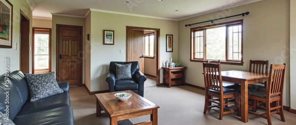 Fototapeta Simple and Sturdy Open-Plan Living and Dining Area with Mission-Style Details and Warm Wood Tones