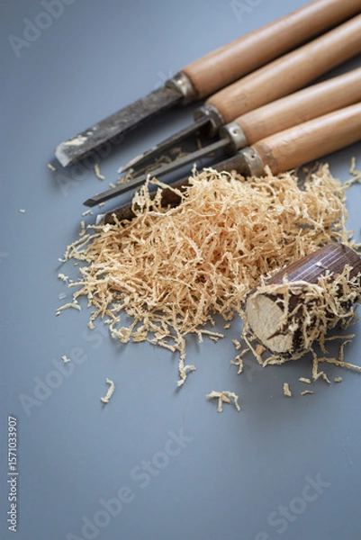 Obraz Chisels and wood shavings in craftsman's workshop on gray background