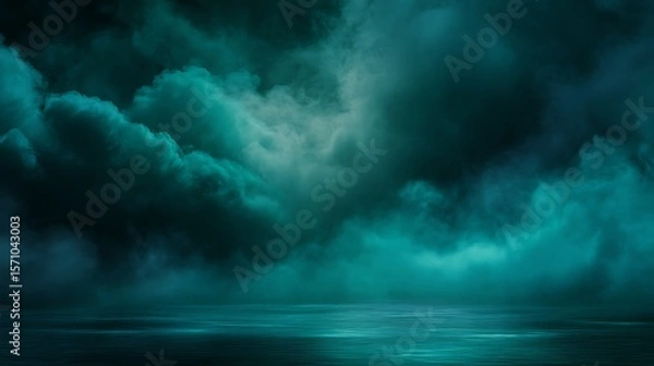 Fototapeta Mysterious teal clouds hovering over calm water reflecting ethereal light and foggy atmosphere
