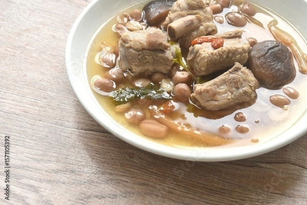 Obraz boiled chop pork bone with peanut and black mushroom soup on plate