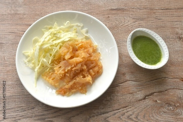 Obraz boiled jellyfish with slice cabbage on plate dipping Thai spicy and sour seafood sauce