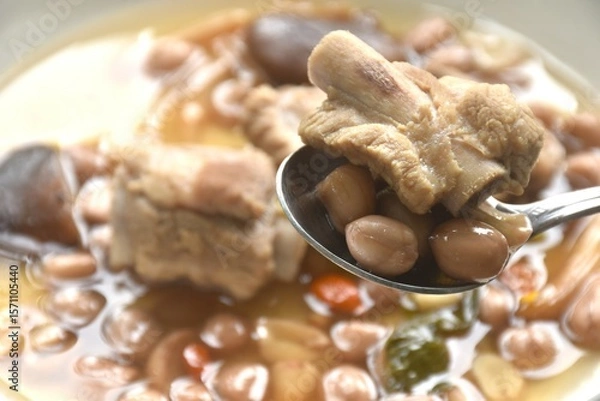 Obraz boiled chop pork bone with peanut and black mushroom soup on plate