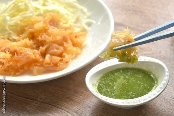 Obraz boiled jellyfish with slice cabbage on plate dipping Thai spicy and sour seafood sauce