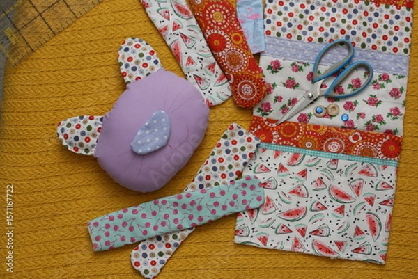 Fototapeta Textile cat made of bright stripes of beautiful cotton fabrics. Concept - handmade, sewing a toy with your own hands.