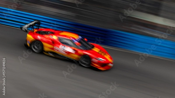Fototapeta Motion blur race car racing on speed track, Motion blurred super car race on street track circuit, Automobile automotive transportation vehicle background,