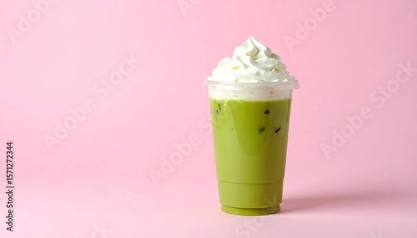 Fototapeta Aesthetic Iced Matcha Coffee Latte in Clear Cup with Pink-Green Milk Layers and Whipped Cream, Set Against a Pastel Pink Background with Soft Shadows and Minimal Styling