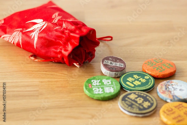 Fototapeta a red bag with different types of traditional chinese tea (compressed), isolated on wooden background