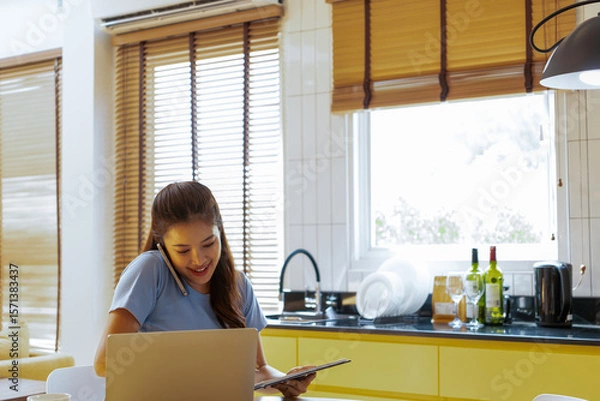 Fototapeta Woman enjoys book and music in modern abode.