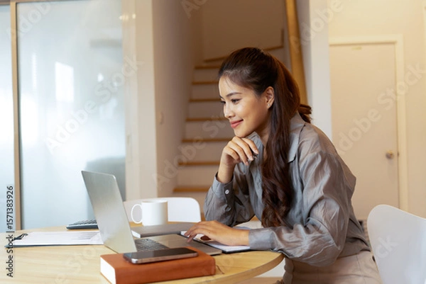 Fototapeta Woman enjoys book and music in modern abode.