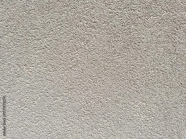 Fototapeta Decorative background in gray-beige tone. Concrete wall covered with decorative textured plaster.