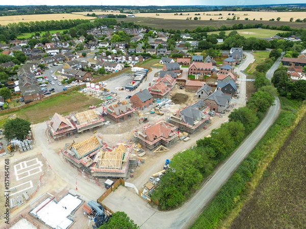 Fototapeta Drone view of a a partially completed British housing development site in rural east anglia. Both affordable and larger private, detached family homes can be seen.