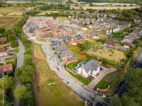 Fototapeta Drone view of a partially completed, exclusive housing development seen in rural Essex. The large White House at the beginning of the estate is the largest here.