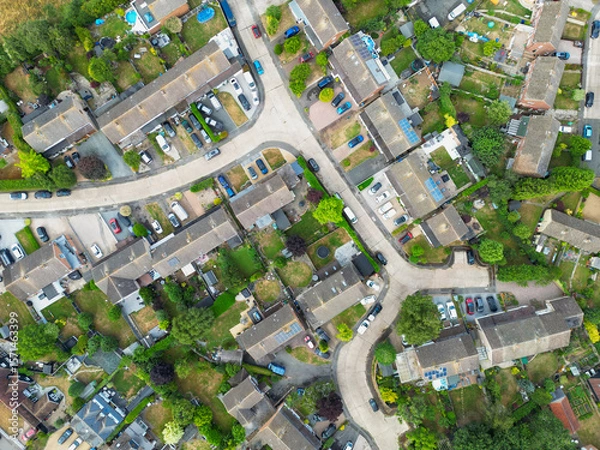 Fototapeta Drone view of a typical British suburban street showing both terraced and detached houses, some with large extensions and fitted solar panels to the roofs.