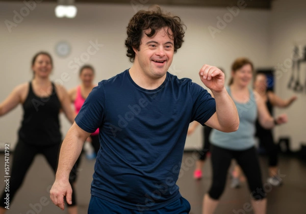 Fototapeta Young man with down syndrome leading energetic dance class indoors, smiling confidently, showcasing joy, confidence, and active lifestyle, diverse group participants in background