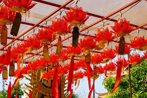 Fototapeta Radiant Red Lotus Lanterns Hanging in a Buddhist Temple Courtyard, Vietnam