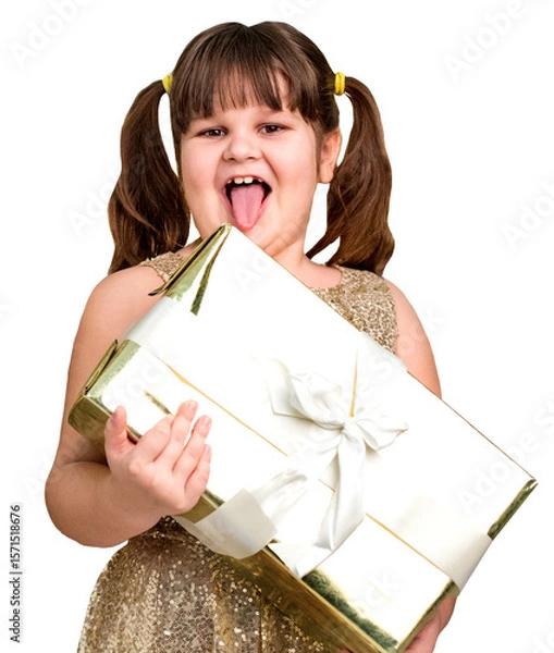 Fototapeta Joyful young girl with pigtails in sparkling dress holding a wrapped gift box and laughing, isolated on transparent cutout background.