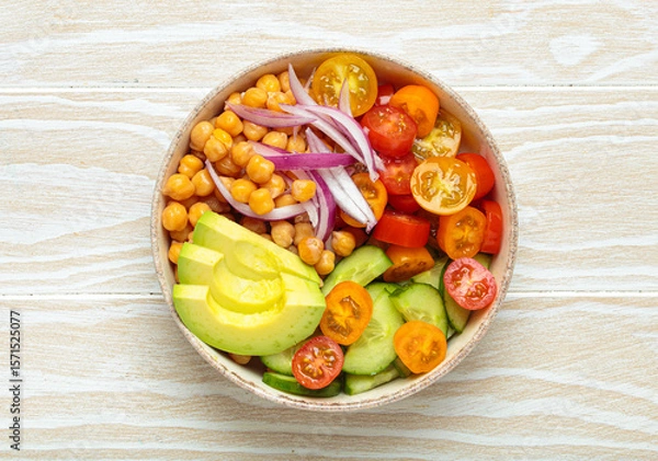 Obraz Healthy chickpea salad with ripe avocado, juicy cherry tomatoes, crisp cucumber, and red onion slices. Perfect for a nutritious and healthy meal