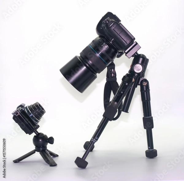 Fototapeta Camera equipment setup features a large DSLR camera and a compact digital camera in a studio environment