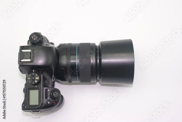 Fototapeta Digital camera with large lens displayed on a white background showcasing photography equipment details